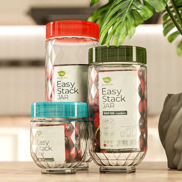 Three 'Easy Stack Jar' containers with colorful lids on a kitchen counter. Three 'Easy Stack Jar' containers with colorful lids on a kitchen counter.