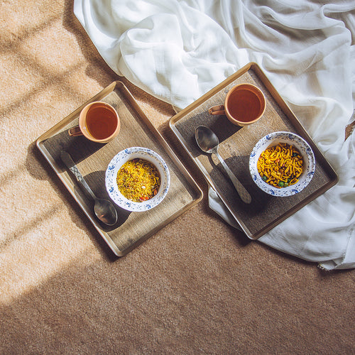 Set of three brown serving trays of different sizes on a white background Set of three brown serving trays of different sizes on a white background