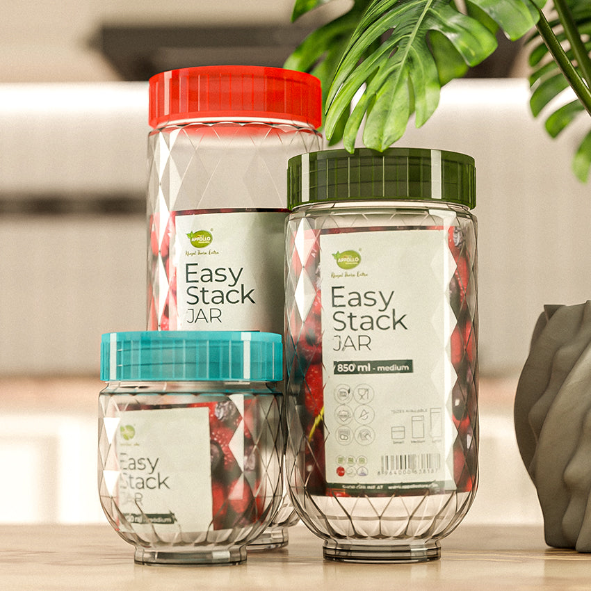 Three 'Easy Stack Jar' containers with colorful lids on a kitchen counter.