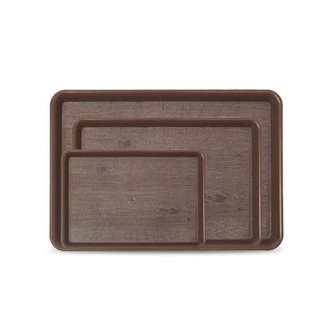 Set of three brown serving trays of different sizes on a white background